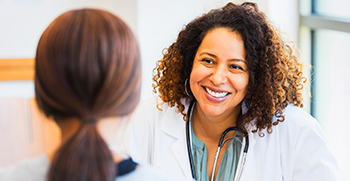 A close-up of a doctor talking to her female patient